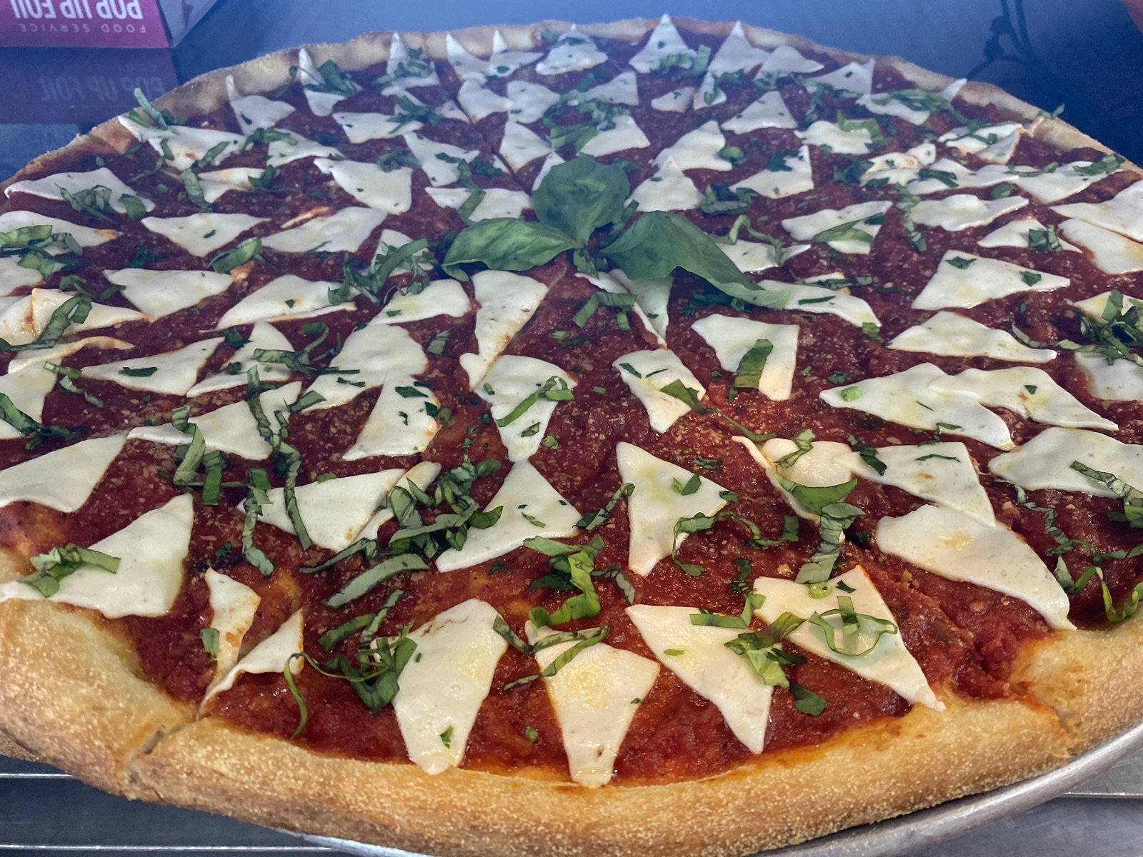 Margherita pizza with fresh mozzarella, basil, and tomato sauce